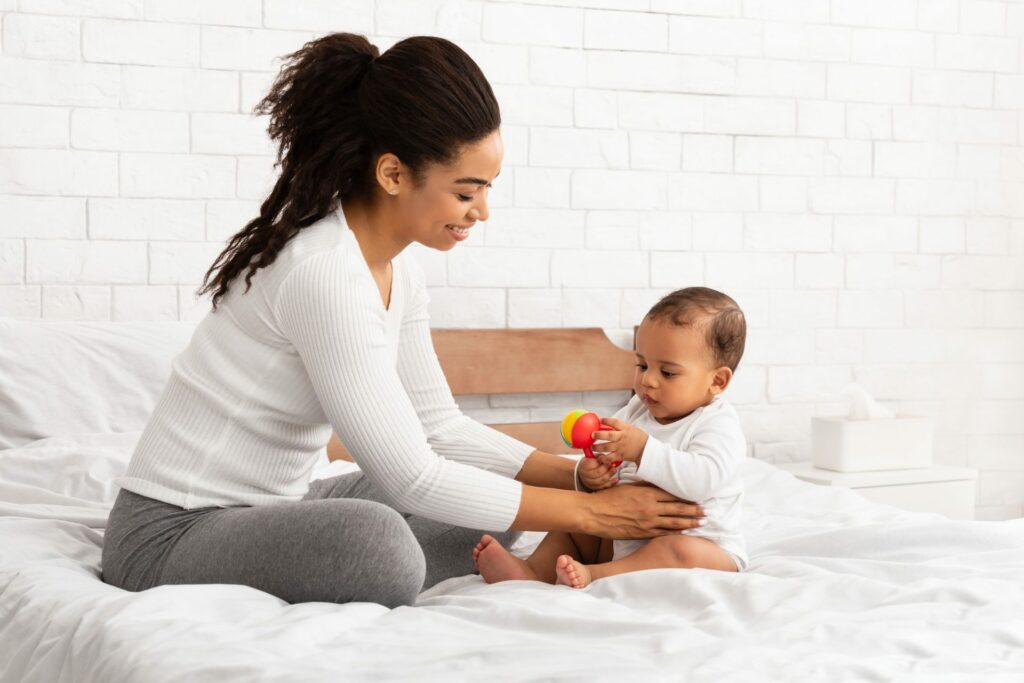 Baby being played with at the day care.